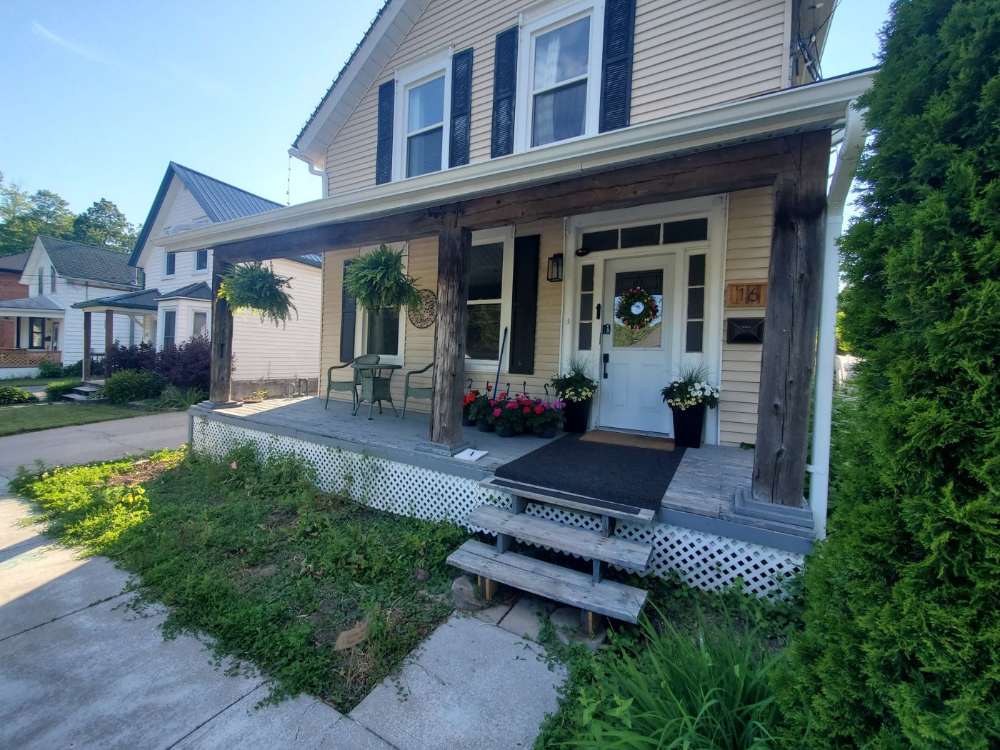 Old front porch with weathered posts and lattice skirt