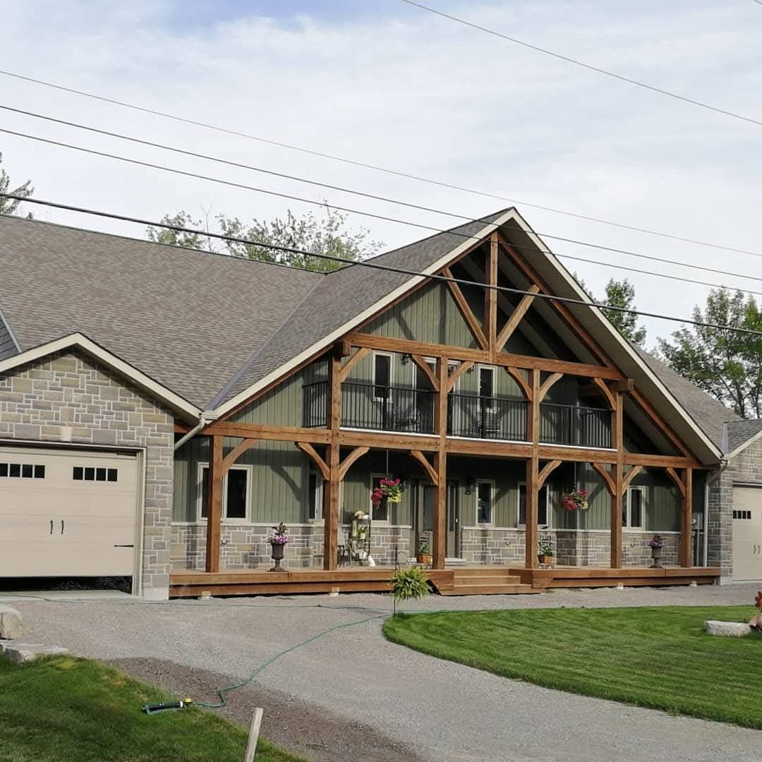 Finished home with an exposed timber frame porch and balcony
